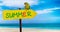 Wooden sign on beautiful beach and clear sea wit text summer. A green parrot sits on a pointer to a tropical paradise