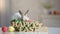 Wooden sign happy Easter and colored eggs on table with cute bunny in basket