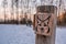 Wooden sign of lynx in winter landscape, walking trail sign leading to lynx sanctuary in Harz Mountains, Germany