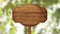 Wooden sign pointer on an animated background of foliage and sun glare