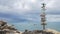 Wooden sign post arrows pointing to various cities and directions against sea view with fisherman boat on background. hd