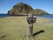 Wooden sign showing the way on a Japanese rocky coast