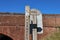 Wooden sign by the side of the canal in Sampford Peverell in Devon pointing the way to the local pubs