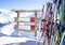 Wooden sign for text near ski and ski pole and ski equipments wint mountains on a background