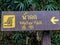 A wooden sign in a Thai forest