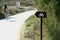 Wooden sign to cycling route into the forest pathway