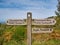 A wooden signpost on a coastal section of the Cleveland Way national trail between Robin Hood`s Bay and Ravenscar, UK