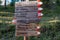 Wooden signpost showing the direction of different hiking paths near Tiers in Italy