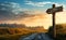 Wooden signpost on the side of a dirt rustic road in front of sunset