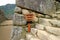 Wooden signpost to the THREE DOORWAYS in the archaeological site of Machu Picchu, Cusco Region, Peru