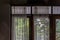 Wooden simple glass of Windows and White lace curtains in traditional thai house