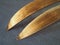 Wooden ski tips, one pair. The underside or inside of the skis, treated with ski wax to improve glide on snow and crust.