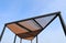 Wooden slats roof with blue sky background.