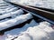 The wooden sleepers are covered with snow. railway arrow in the snow.