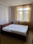 Wooden sleeping bed with white mattress