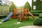 Wooden slides, children`s toys In the green lawn