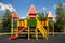 Wooden slides made of natural red yellow wood on the playground on a bright sunny day. Playgrounds, sports, health