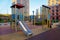 Wooden slides made of yellow blue timber on the playground in the courtyard of a residential building