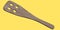 Wooden slotted turner or kitchen utensils on yellow background.