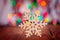 Wooden Snowflake on colorful boke background with copy space, se