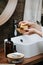 Wooden soap dish in hands of a mature woman with an eco soap block