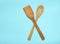 Wooden spatula for cooking on blue background. Kitchen concept, minimalism.