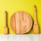 Wooden spatula, pestle and wooden round cutting Board, on a whit