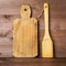 Wooden spatula and rustic old cutting Board on brown dark wooden