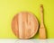 Wooden spatula and wooden round cutting Board, on a white table