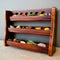 a wooden spice rack with spices and herbs