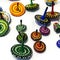 Wooden spinning tops of different sizes and colors. Image of jewish holiday Hanukkah with wooden dreidels