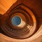 Wooden spiral staircase in the interior of a modern office building. generative ai