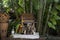 Wooden Spirit house with dolls in summer garden