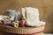 Wooden spools of multi color threads, rolls of beige and grey cotton lace on sewing rattan wicker basket, hobby, crafts