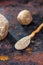 Wooden spoon with asafoetida powder on rusty background.