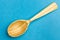 Wooden spoon on a blue  background.Spoon with textured tree. Trend Colors . Copy space