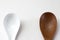 Wooden spoon and ceramic spoon isolated on a white background