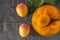 Wooden spoon of dark wood in a bowl of apricot jam on a rustic table.