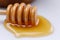 Wooden spoon with a drop of tasty liquid on a white background. Close-up