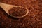 Wooden spoon on dry rooibos leaves, closeup view