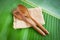 Wooden spoon and fork kitchenware set on sack banana leaf background