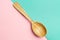 Wooden spoon on a Geometric pink and turquoise background.Spoon with textured tree. Trend Colors . Copy space
