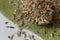 Wooden spoon on the green cloth. With white background. Barley, millet and corn. Mixed cereals together. Green