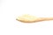 Wooden spoon with a heap of white sesame grain isolated on a white background
