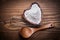 Wooden spoon heartshaped bowl flower egg-whisk on wood board