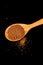 Wooden Spoon with Instant Cocoa Powder on Black Background