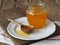 Wooden spoon with a jar of natural rustic honey from a private apiary on a plate.The concept of the health benefits of honey