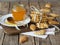 Wooden spoon with a jar of natural rustic honey and a stack of homemade cookies on a wooden background.The concept of the health