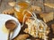 Wooden spoon with a jar of natural rustic honey and a stack of homemade cookies on a wooden background.The concept of the health