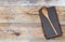 Wooden spoon and kitchen towel on untreated wood